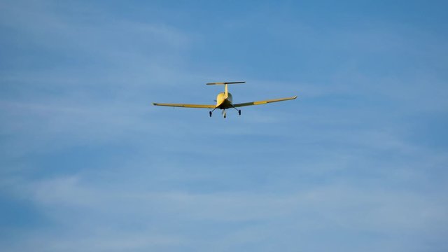 Ultralight small yellow aircraft airplane flying in the sky over the airfield. Aviation festival holiday at the aerodrome 