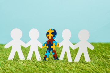 Special kid with autism among another on blue and green background