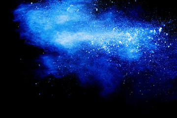 Blue color dust particles explosion cloud on black background.Color powder splash. - Powered by Adobe