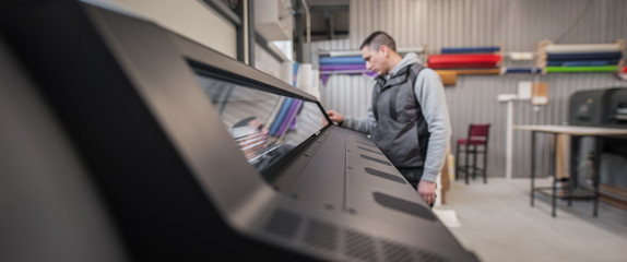 Technician operator checking status on touchscreen front display monitor station