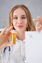Female doctor hands hold and give to visitor prescription and jar of pills closeup. Panacea life save healthy lifestyle prescribe treatment legal drug store contraception concept