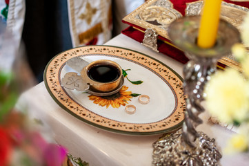 church silver chalice with wine on the plate