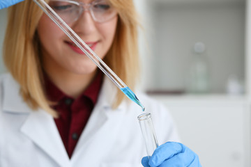 Technician hold in arms in protective gloves sample bottle with poison fluid portrait. Medical worker in uniform use reagent tube for virus infection exam or biological toxic reaction drug creation