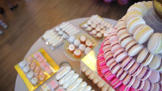 table with sweet cookies, eclairs, cakes. candy bar camera move down