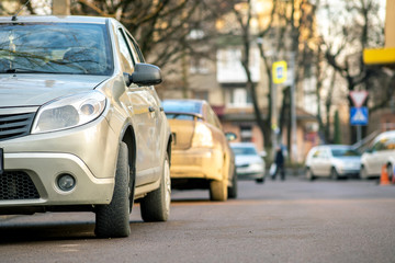 Kyiv, Ukraine - February 16, 2020: Modern cars parked on city street side in residential discrict. Shiny vehicles parked by the curb. Urban transportation infrastructure concept.