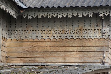 wooden texture of gray and brown boards in the old wall with a carved pattern