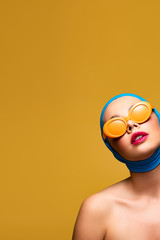 elegant naked girl in scarf and fashionable sunglasses, isolated on yellow