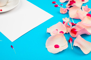 Composition with beautiful petals and notebook on color background. Wish list concept