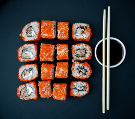 Japanese food. Sushi. Philadelphia roll with fresh salmon, cucumber, avocado, cream cheese, tobiko caviar. Sushi menu. Top view