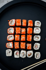 Japanese food. Sushi. Philadelphia roll with fresh salmon, cucumber, avocado, cream cheese, tobiko caviar. Sushi menu. Top view