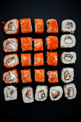 Japanese food. Sushi. Philadelphia roll with fresh salmon, cucumber, avocado, cream cheese, tobiko caviar. Sushi menu. Top view