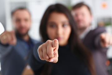 cheerful young businessmen are happy to work together friendly team have success results point your finger at you