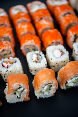 Japanese food. Sushi. Philadelphia roll with fresh salmon, cucumber, avocado, cream cheese, tobiko caviar. Sushi menu. Top view