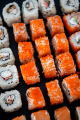 Japanese food. Sushi. Philadelphia roll with fresh salmon, cucumber, avocado, cream cheese, tobiko caviar. Sushi menu. Top view