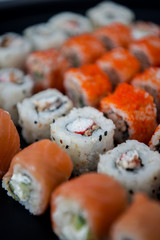 Japanese food. Sushi. Philadelphia roll with fresh salmon, cucumber, avocado, cream cheese, tobiko caviar. Sushi menu. Top view