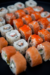 Japanese food. Sushi. Philadelphia roll with fresh salmon, cucumber, avocado, cream cheese, tobiko caviar. Sushi menu. Top view