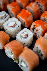 Japanese food. Sushi. Philadelphia roll with fresh salmon, cucumber, avocado, cream cheese, tobiko caviar. Sushi menu. Top view