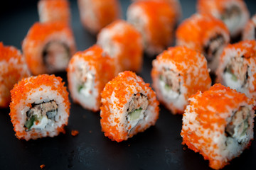 Japanese food. Sushi. Philadelphia roll with fresh salmon, cucumber, avocado, cream cheese, tobiko caviar. Sushi menu. Top view