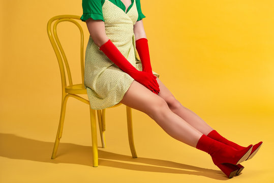cropped view of pop art girl sitting on chair