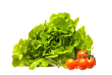 Fresh lettuce leaves and cherry tomatoes isolated on a white background.