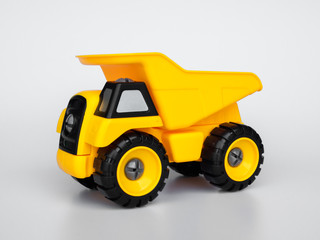 Yellow plastic truck  toy isolated white background.