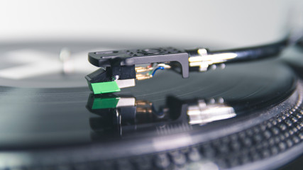 Close-up of modern turntable vinyl record player with music plate. Needle on a vinyl record.