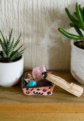 burning Palo Santo, sacred root, magic stones
