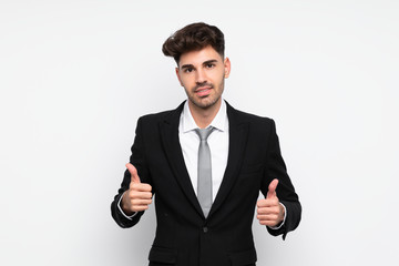 Young businessman over isolated white background giving a thumbs up gesture