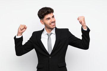 Young businessman over isolated white background celebrating a victory