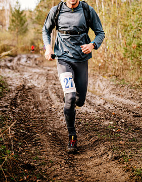 Male Runner Run On Muddy Trail Autumn Marathon Race