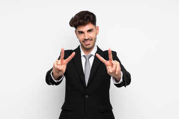 Young businessman over isolated white background smiling and showing victory sign