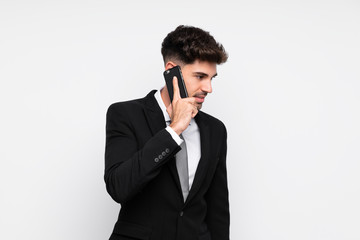 Young businessman with mobile phone over isolated white background