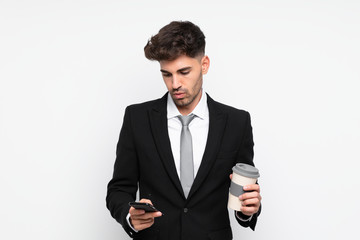 Young businessman holding coffee to take away over isolated white background