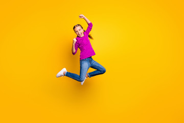 Fototapeta na wymiar Full length body size view of her she nice attractive lovely cheerful cheery girl jumping rejoicing having fun pass test exam isolated on bright vivid shine vibrant yellow color background