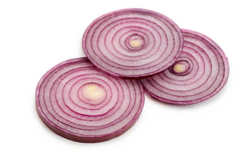 Few circle slices of red onion on white background