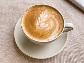 Cup of coffee on beige background.