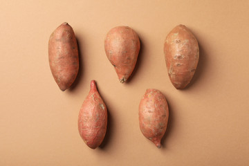 Flat lay with sweet potato on craft background, top view