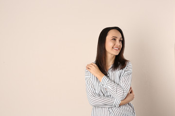Fototapeta premium Portrait of beautiful mature woman on beige background. Space for text