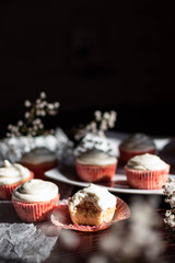 Bitten cupcake standing on the background of others, black background