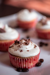 One cupcake against the background of others standing on a white plate