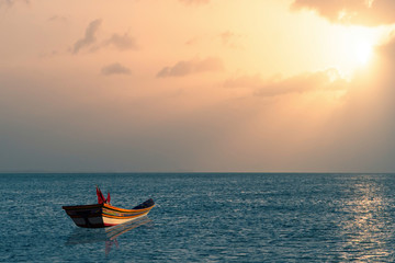 Naklejka na ściany i meble boat in sea at sunset