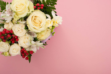 top view of bouquet of flowers on pink background