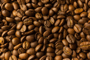 Roasted Arabica beans close up, coffee background