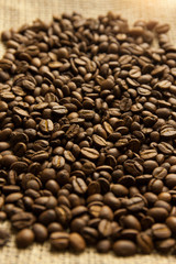 Roasted Arabica beans close up, coffee background