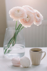 Spring home interior decor. Coffee cup, flowers, book. Decorated interior in living room. Blog, website or social media concept 