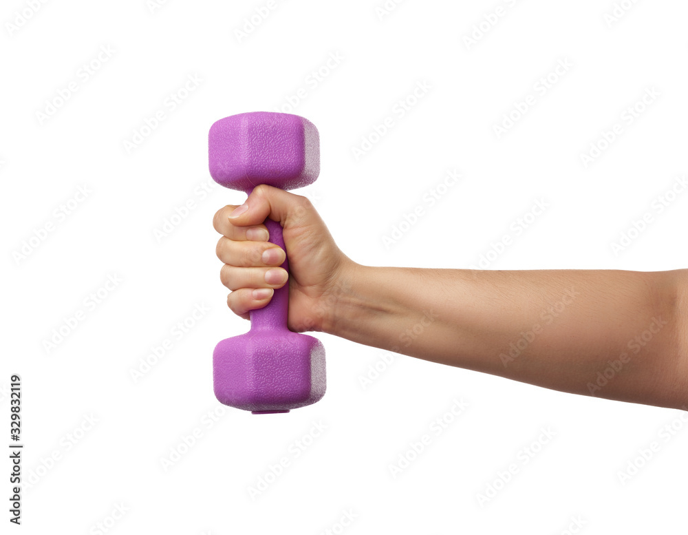 Wall mural female hand holds a plastic pink dumbbell on a white isolated background