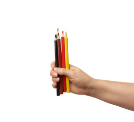 female hand holds multi-colored wooden pencils