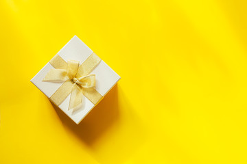 beautiful gift with ribbon on a bright yellow background, Mother's day