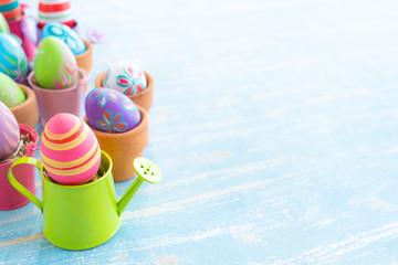 Naklejka premium groups of colorful easter eggs in the basket on the blue wooden table preparing for cerebrating the event