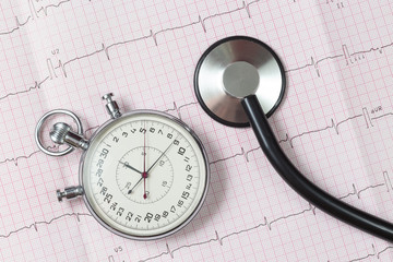 stethoscope and stopwatch on the cardiogram